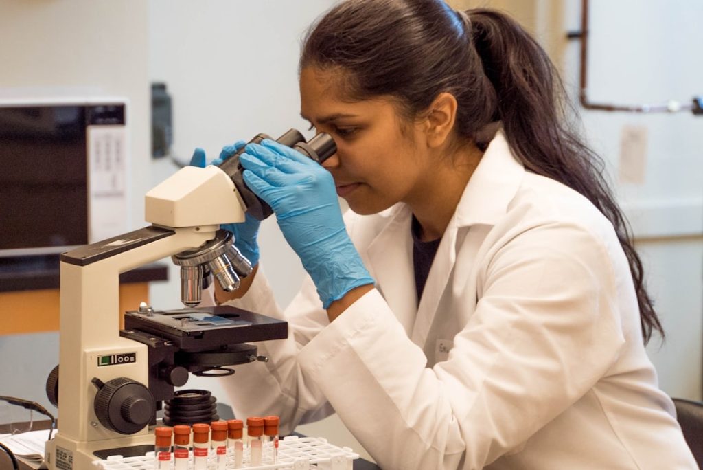 professional-viewing-specimen-with-microscope